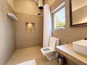 A modern bathroom with a shower, toilet, and sink. - King's Abode (Kumbhalgarh)