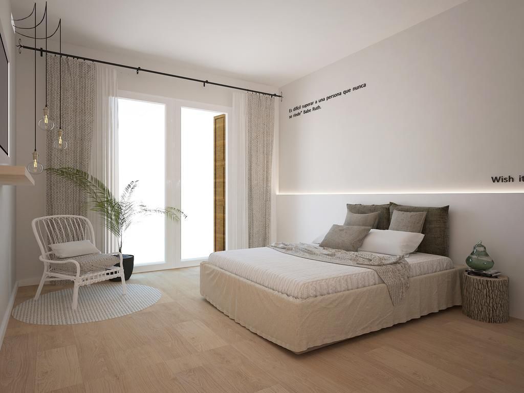 Un dormitorio con cama, una silla, una planta y una mesita de noche.