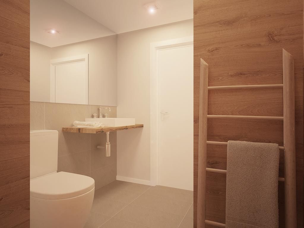 Un baño moderno con inodoro, lavamanos y tocador de madera.