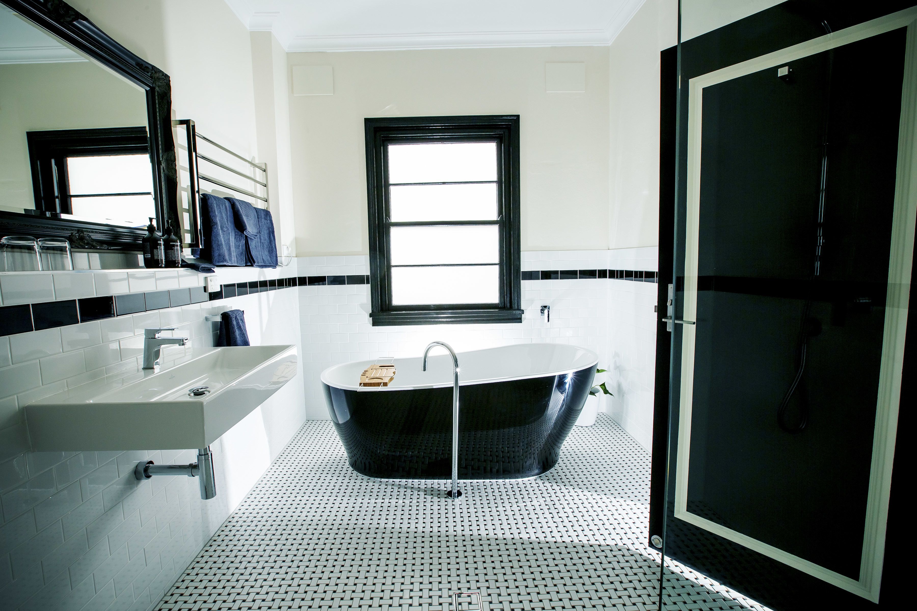 Un baño moderno con una bañera independiente, un lavamanos y una zona de ducha.