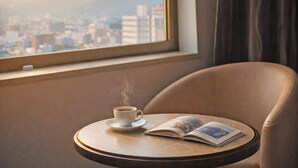 A small round table with a cup of coffee and an open magazine. - The Celecton Fukushima (Fukushima)