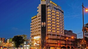 A multi-story hotel with a prominent entrance, a vertical sign with the hotel's name, and a series of windows on each floor. - The Celecton Fukushima (Fukushima)