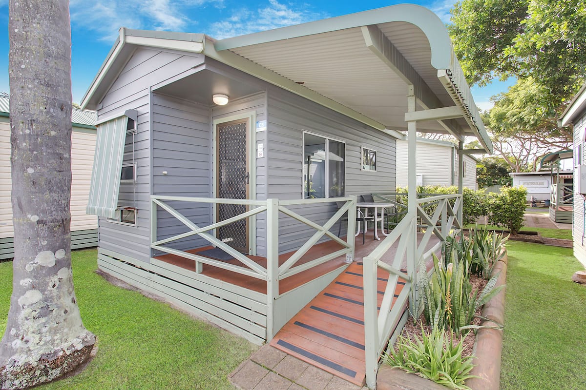 A single-story house with a covered porch and a small deck.