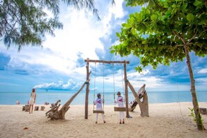 White sand, sun loungers, beach umbrellas, beach towels