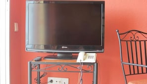 A television on a stand with a telephone. - Apartamentos Amazonas (San Bartolomé de Tirajana)