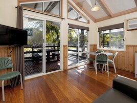 Standard Poolside 2 Bedroom Villa | Living area | Flat-screen TV, table tennis, books