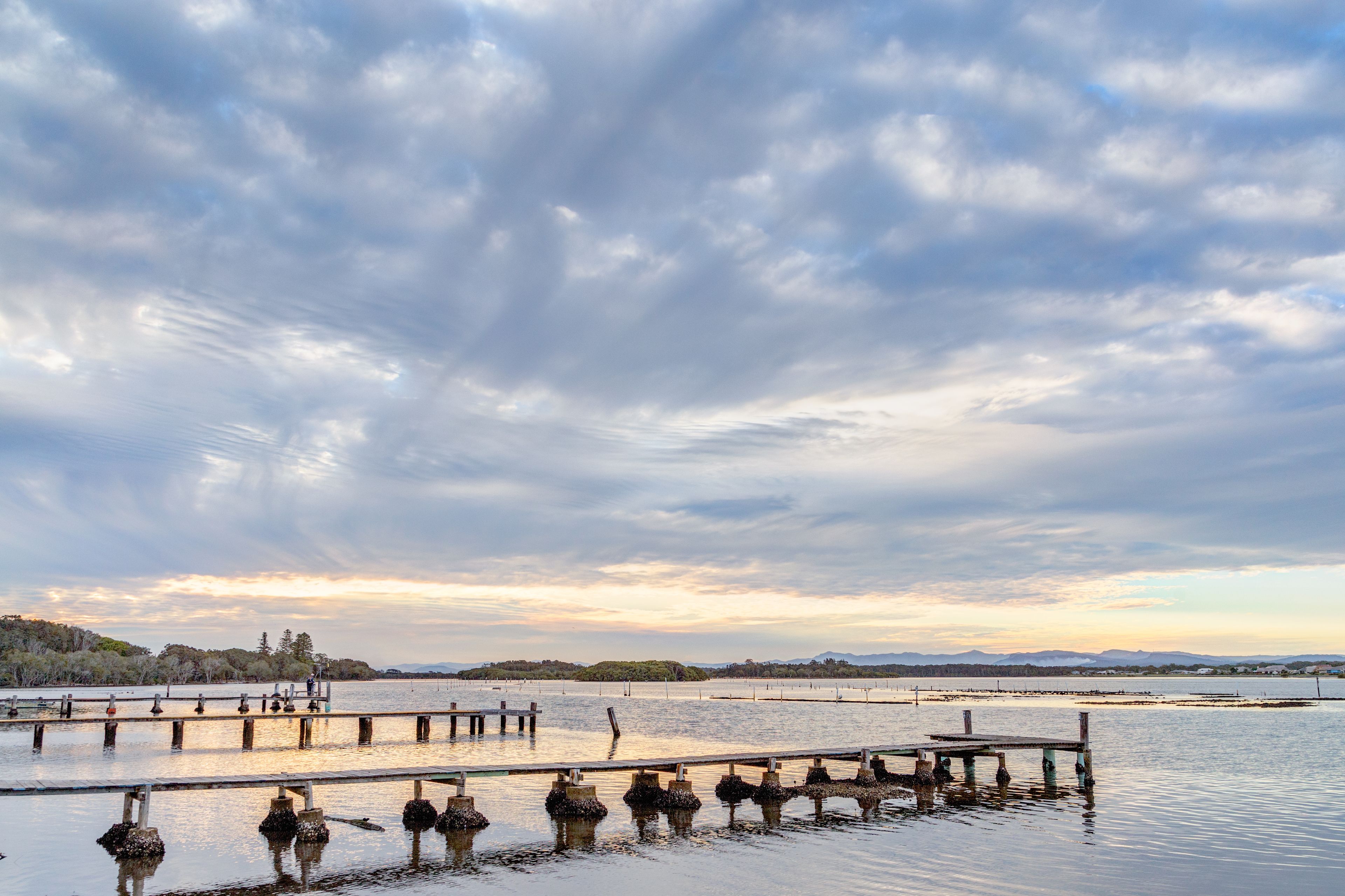 A calm lake with a wooden pier extending into the water.