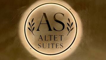 A circular sign with the text 'AS ALLET SUITES' indicating the name of a hotel or accommodation.