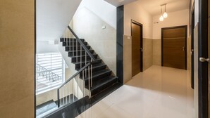 A modern interior with a staircase, a door, and a light fixture. - Treebo Corner Stay, Coimbatore (Coimbatore)