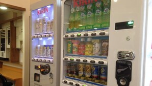 Vending machines with various beverages and snacks, including Kirin and Coca-Cola, in a public indoor setting. - Hotel Select Inn Nagano (Nagano)