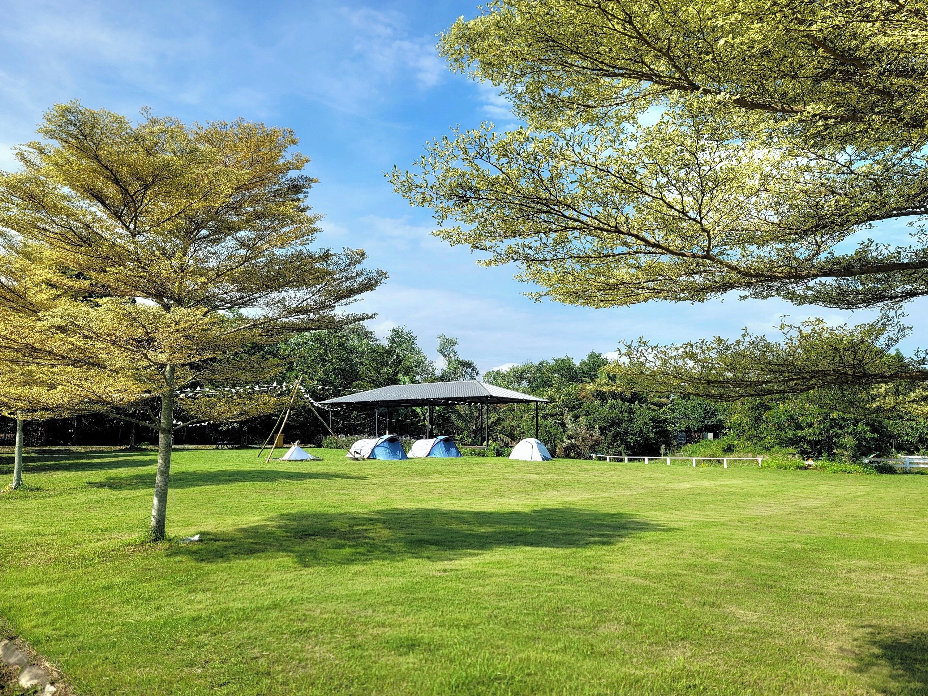 A campsite with tents and a pavilion.