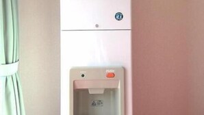 A white ice dispenser with the word "ICE" on it, located on a wall. - Hotel Select Inn Tsuyama (Tsuyama)