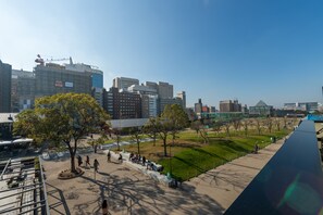 Un paisaje urbano con edificios modernos, un parque con árboles y un largo sendero.