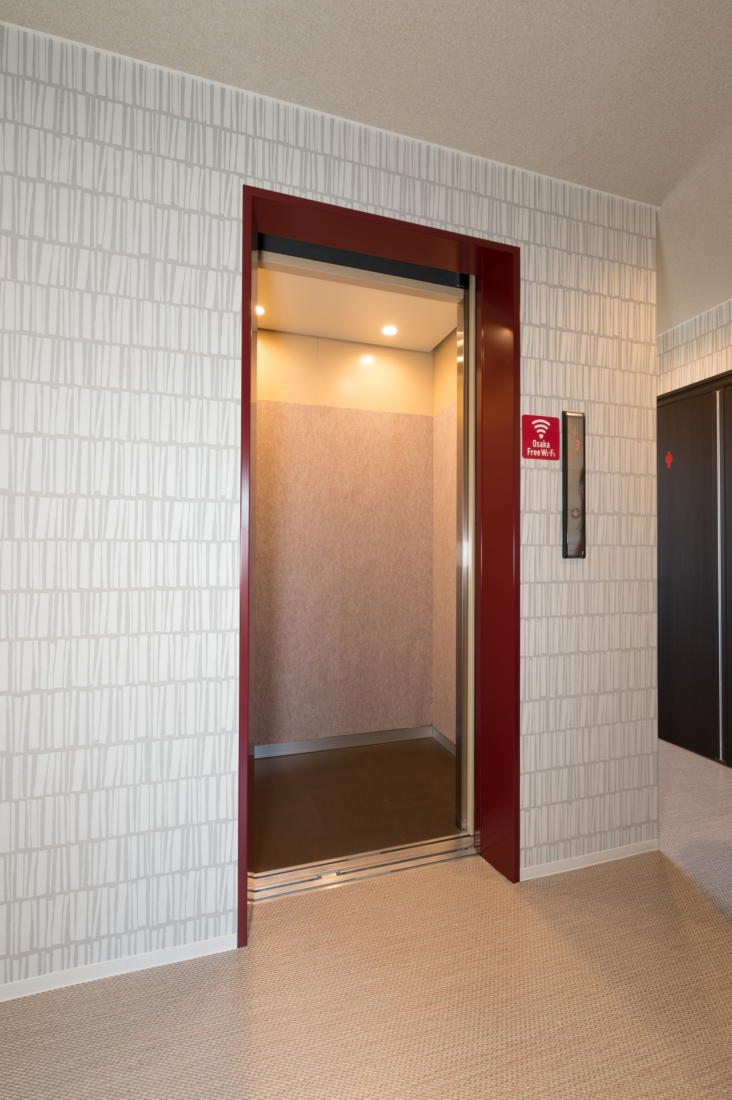 An elevator with a sign indicating free Wi-Fi.