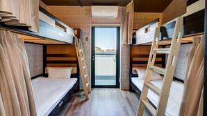 A compact, well-lit room with bunk beds, a door leading outside, and a ladder for access. - Kintetsu Friendly Hostel Tennojipark Osaka (Osaka)