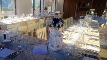 A dining area with tables set for a meal, chairs, and a decorative centerpiece.