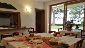 A dining area with a table set for four, featuring a checkered tablecloth, plates, cutlery, and a variety of food items. - B&B Luna Di Langa (Alba)