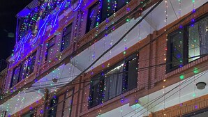 A multi-story building with a shop on the ground floor named "Nepal Art Gallery" and another shop named "Menboob". - Bag Packer's Lodge (Kathmandu)