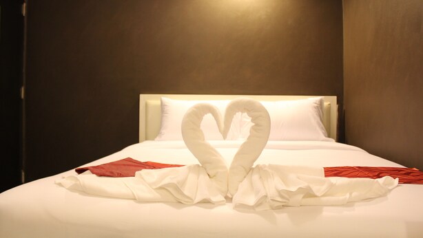 A hotel room with a bed featuring a heart-shaped towel arrangement. - S30 Sukhumvit Hotel (Bangkok)