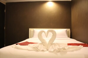 A hotel room with a bed featuring a heart-shaped towel arrangement. - S30 Sukhumvit Hotel (Bangkok)