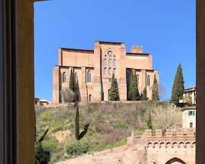 A large, historic building with multiple arched windows and a prominent central tower. - Siena Vip (Siena)