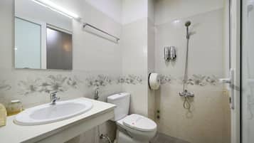 Un baño con lavamanos, inodoro y ducha.