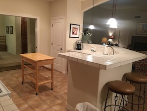 Enjoy cooking in this well-equipped kitchen with a central island, sink, and stove.
