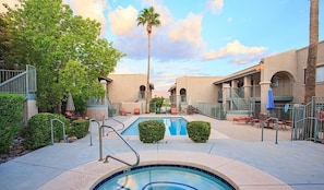 A pool area with a hot tub, lounge chairs, and palm trees. - Perfect at Pantano By Signature Vacation Rentals (Tucson)