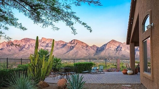 A patio with outdoor furniture, a cactus garden, and a mountain view. - Scenic Spectacular By Signature Vacation Rentals (Oro Valley)