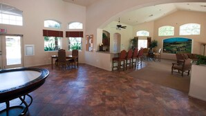 A spacious lobby with a pool table, multiple seating areas, and large windows providing natural light. - Paradise Found By Signature Vacation Rentals (Scottsdale)