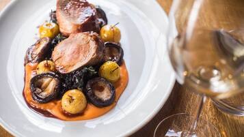 A plate of food with a glass of wine.
