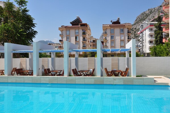 Seasonal outdoor pool, open 9 AM to 10:30 PM, pool umbrellas