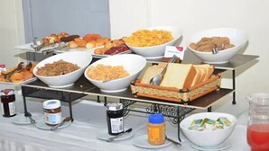 A buffet with various food items including pastries, cereals, and sandwiches. - Sky Hotel Nairobi (Nairobi)