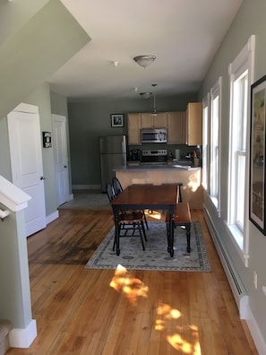 A kitchen with wooden cabinets, a built-in oven, and a microwave. - 109 Main Street (Stowe)