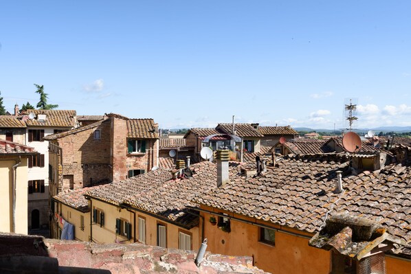 A view of a historic town with terracotta-tiled roofs and traditional architecture.