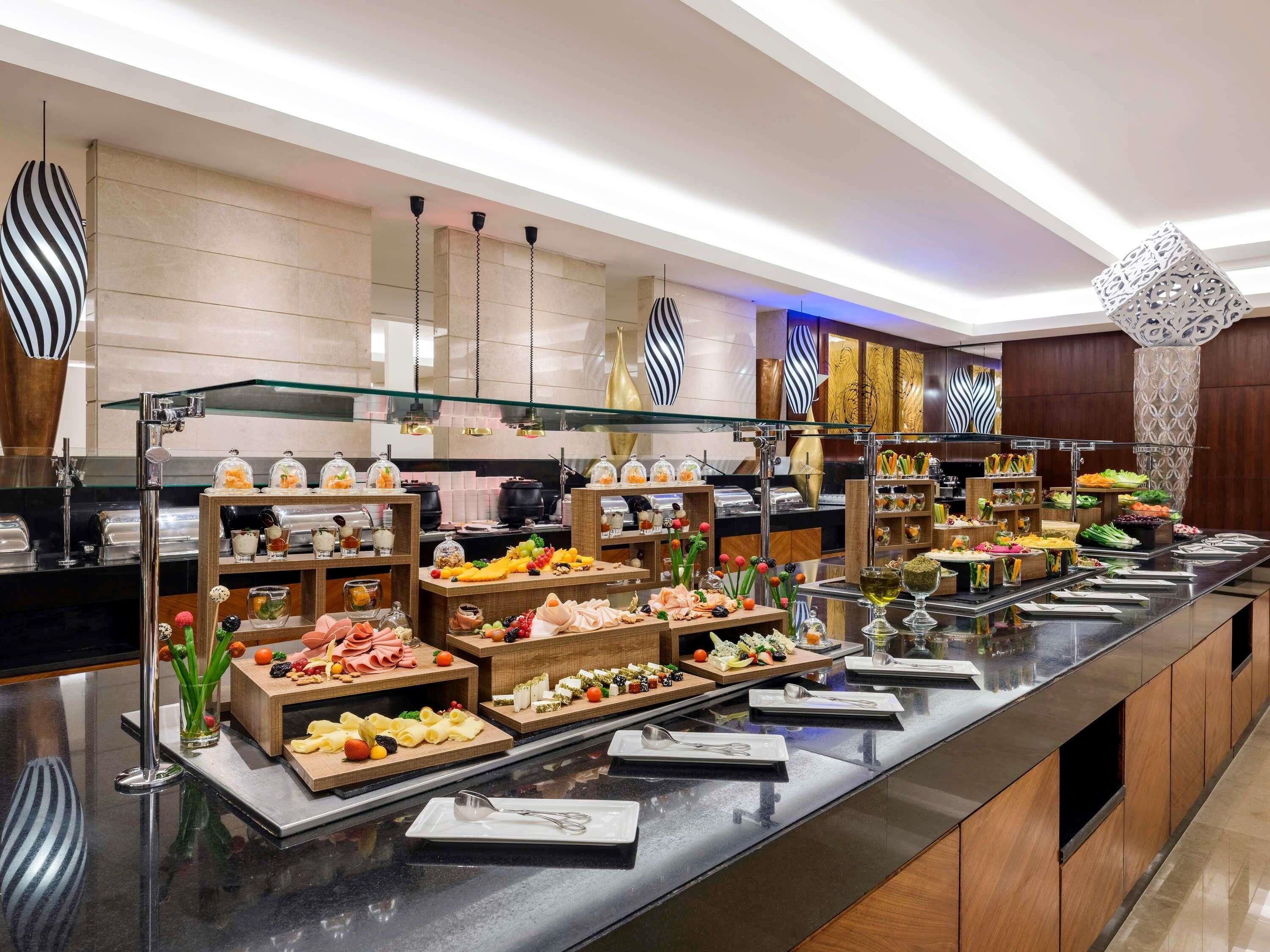 A buffet with various food items and a glass display case.