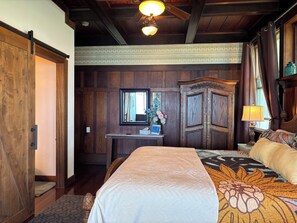 A wooden room with a bed, a desk, and a wardrobe. - Hilo Bay Oceanfront B&B (Hilo)