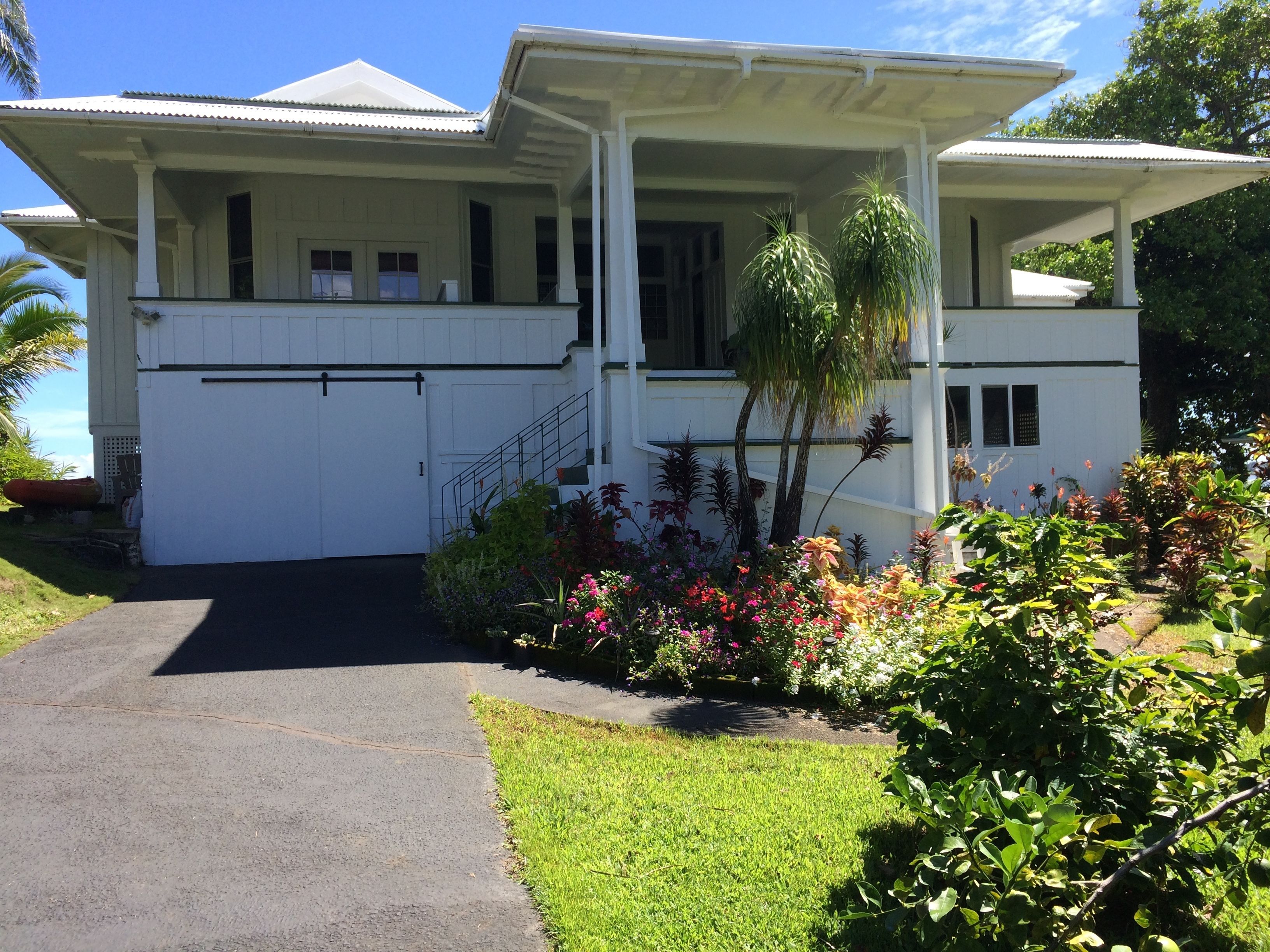A two-story house with a covered porch and a garage.