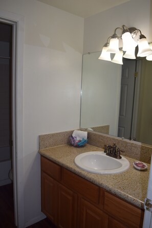 Townhome | Bathroom | Combined shower/tub, free toiletries, towels - Mactavish Court Townhomes (Rawlins)