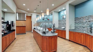 A modern kitchen with wooden cabinets, a central island, and a tiled backsplash.