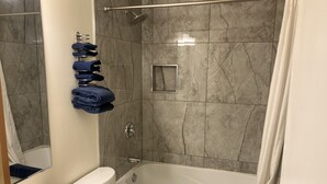 A bathroom with a bathtub, toilet, and sink. - Florence Motel (Smithers)