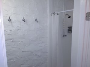Family Suite, Multiple Beds, Refrigerator & Microwave, Courtyard Area | Bathroom | Hydromassage showerhead, free toiletries, towels, soap