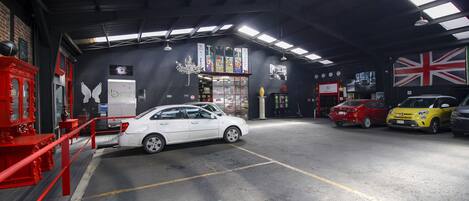 A car wash facility with multiple cars, a red fire extinguisher, and a British flag.