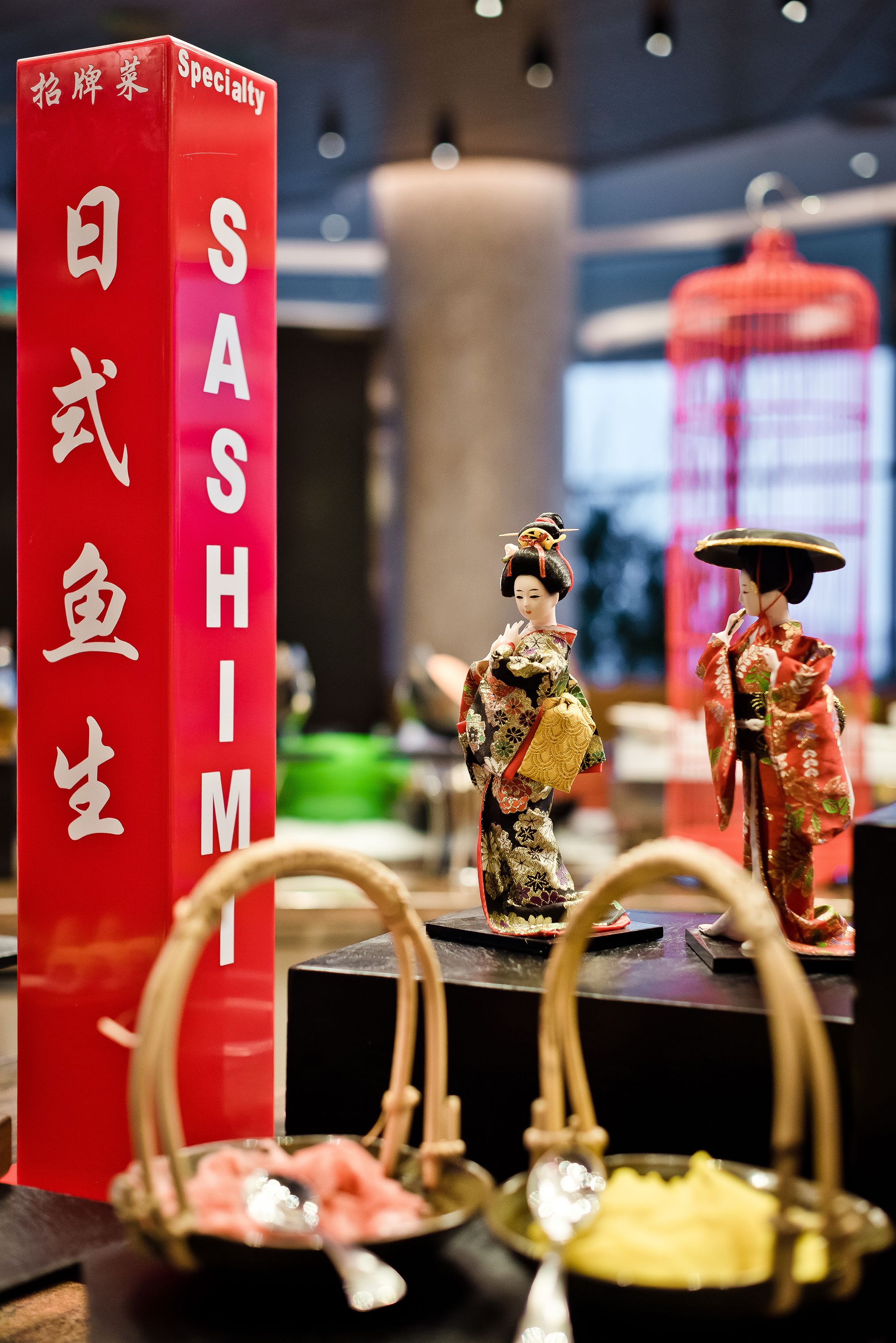 A display of Japanese sushi with a red sign reading "SUSHIMI".