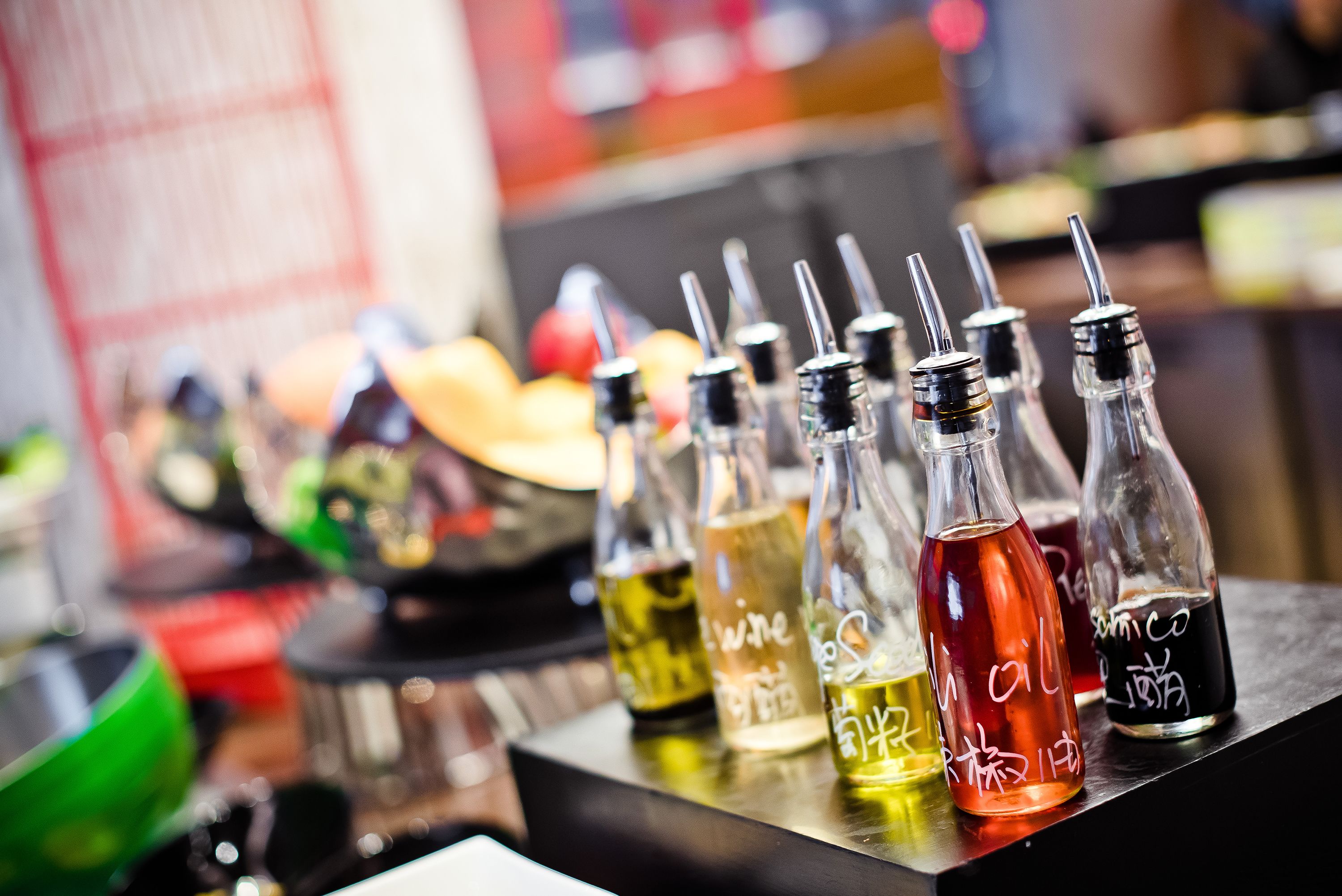 A bar with various bottles of alcohol, including whiskey and vodka, on a counter.