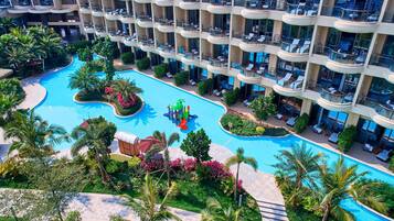 Guests can enjoy a refreshing swim in the hotel's large pool surrounded by lush greenery and scenic views.