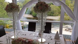 A table set for a wedding reception with a view of a river and greenery. - The Meetings B&B (Avoca)