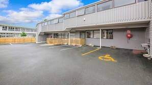 Un immeuble à plusieurs étages doté d’un espace de stationnement réservé aux personnes handicapées.