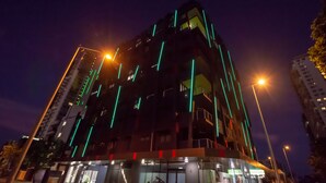 A modern building with a glass facade and green vertical lighting accents. - Magnum Serviced Apartments (Darwin)