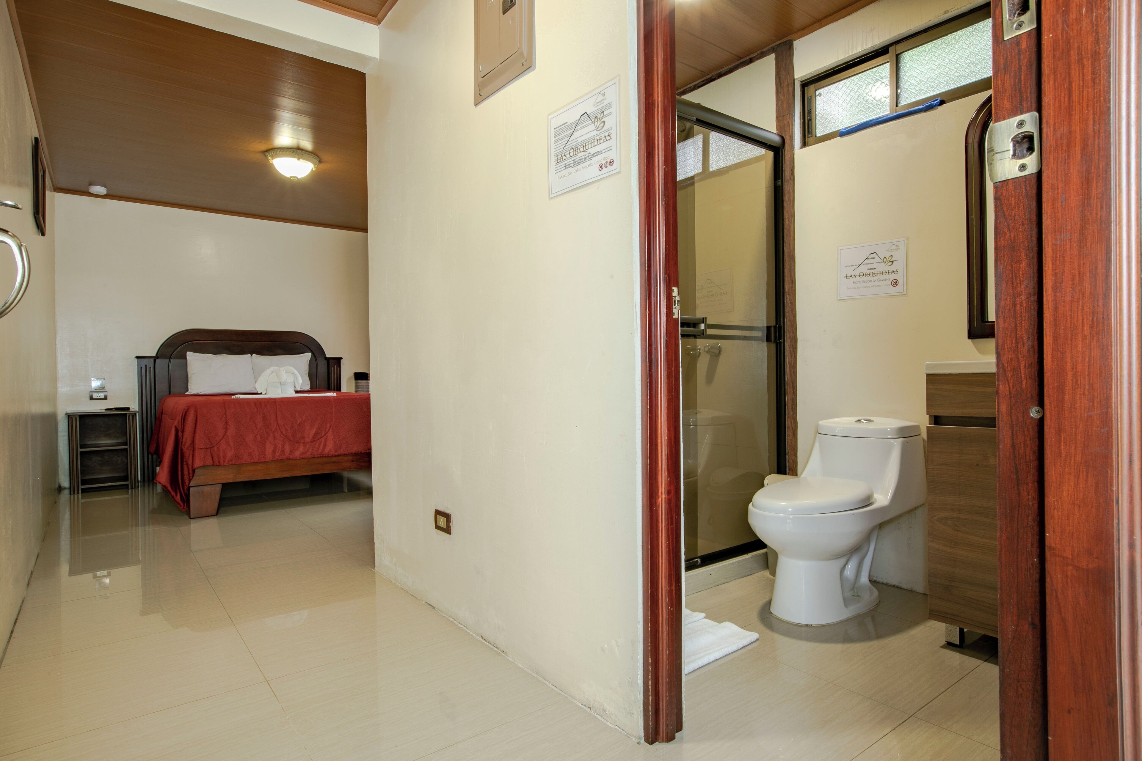 Une chambre d’hôtel équipée d’un lit, de toilettes et d’une douche.